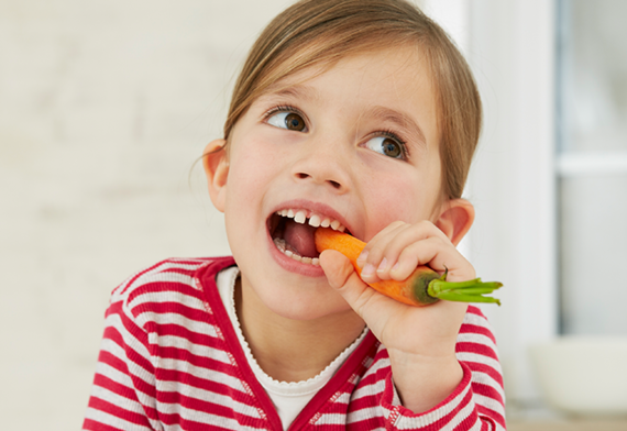 Child eating carrot