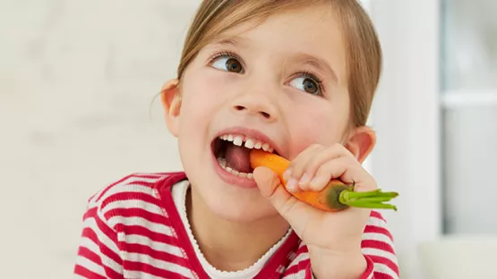 Child eating carrot